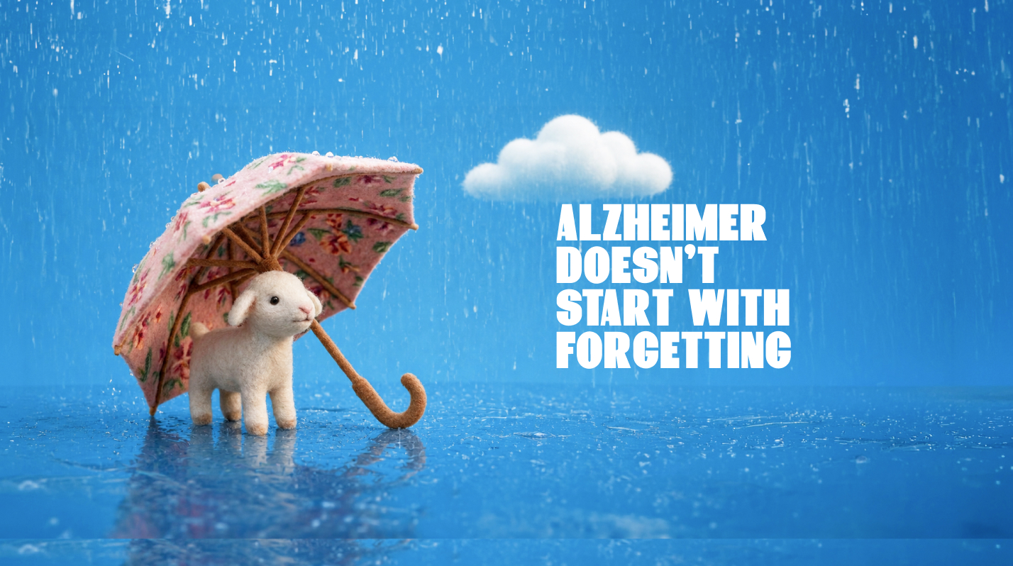 Alzheimer's doesn't start with forgetting — a lamb shelters under a floral umbrella in the rain